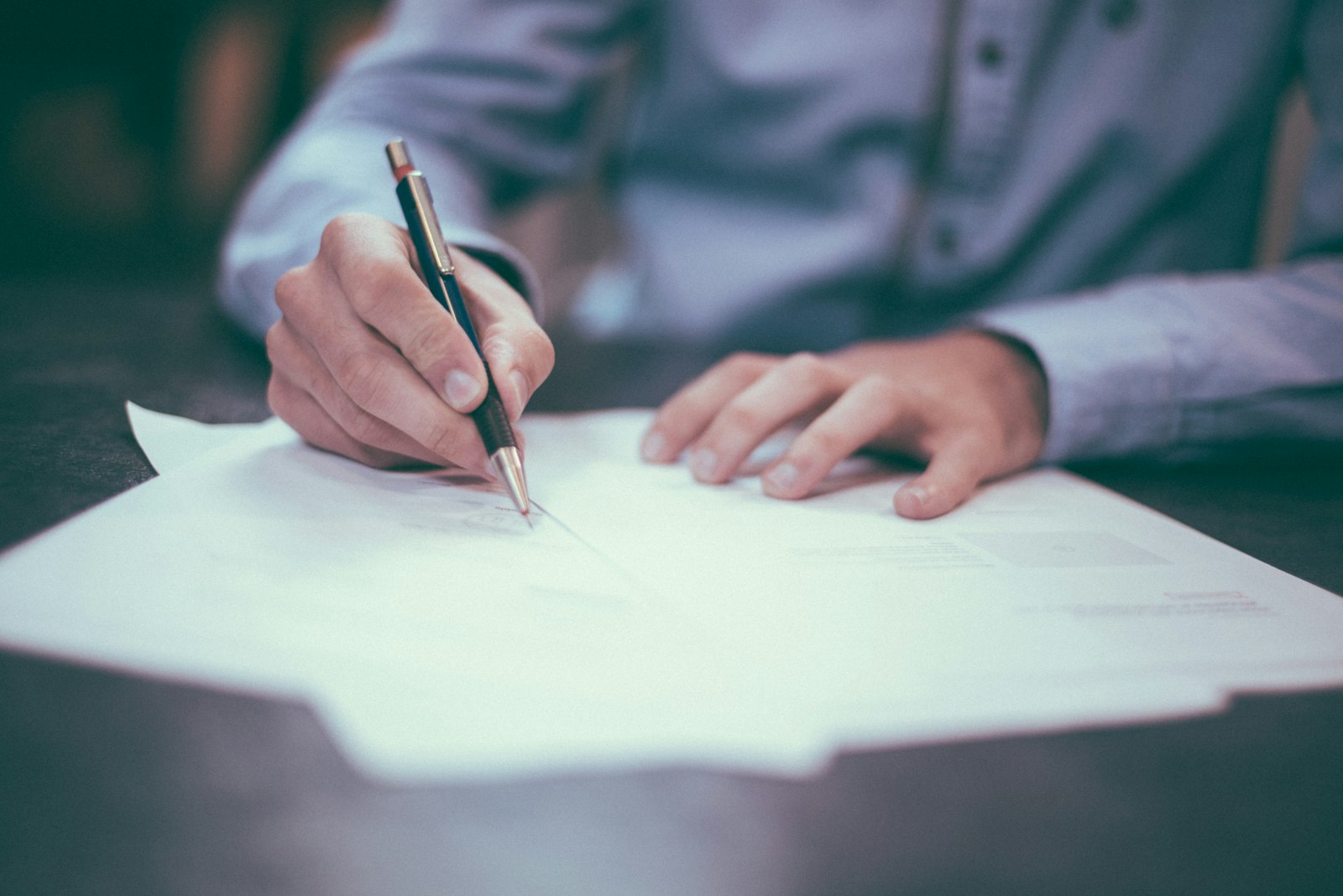 A planner's hands writing notes during a planning session